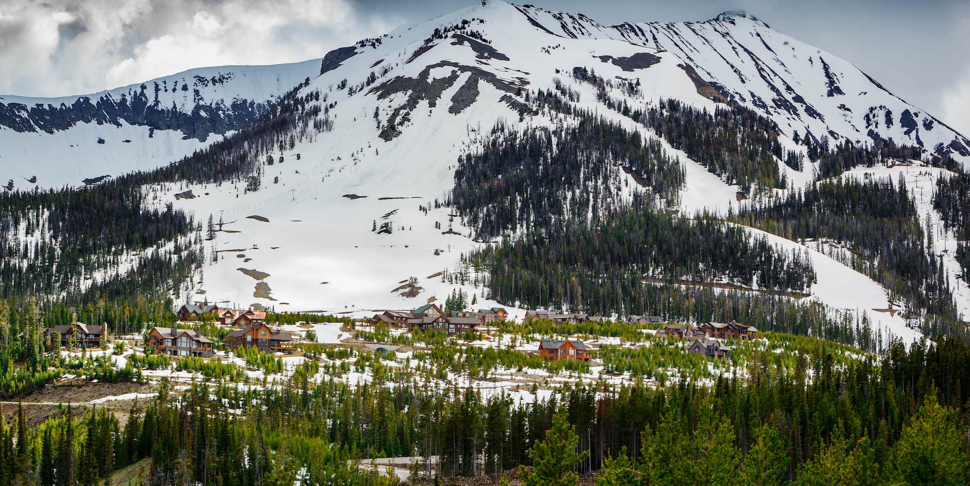 Moonlight Basin ski resort Montana set amongst pine trees and snow capped mountains in the Madison Range of the Rocky Mountains of Big Sky Montana,USA
